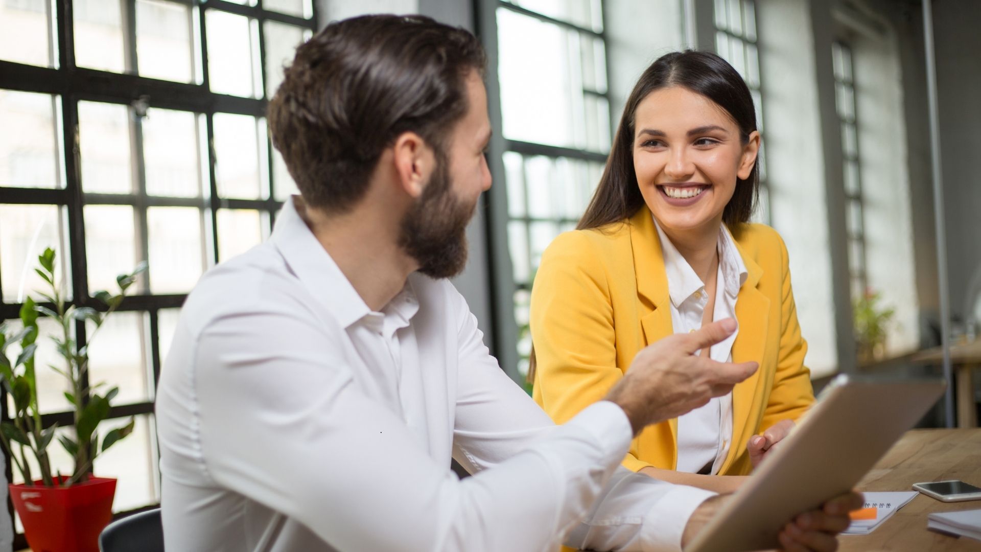accountant and bookkeeper talking over financial documents