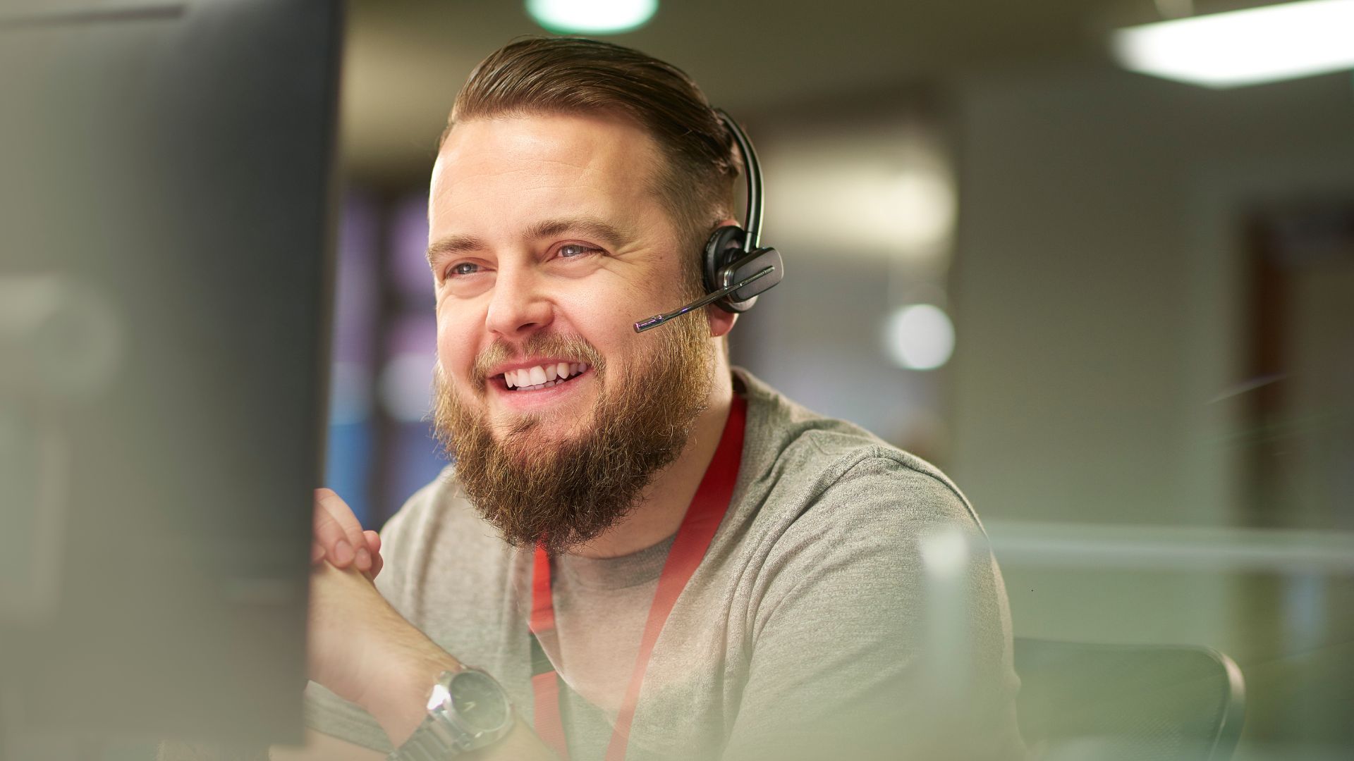 man on earpiece talking to a client in an office