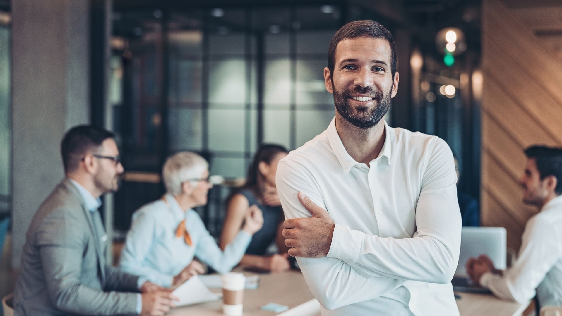successful company owner in front of his team