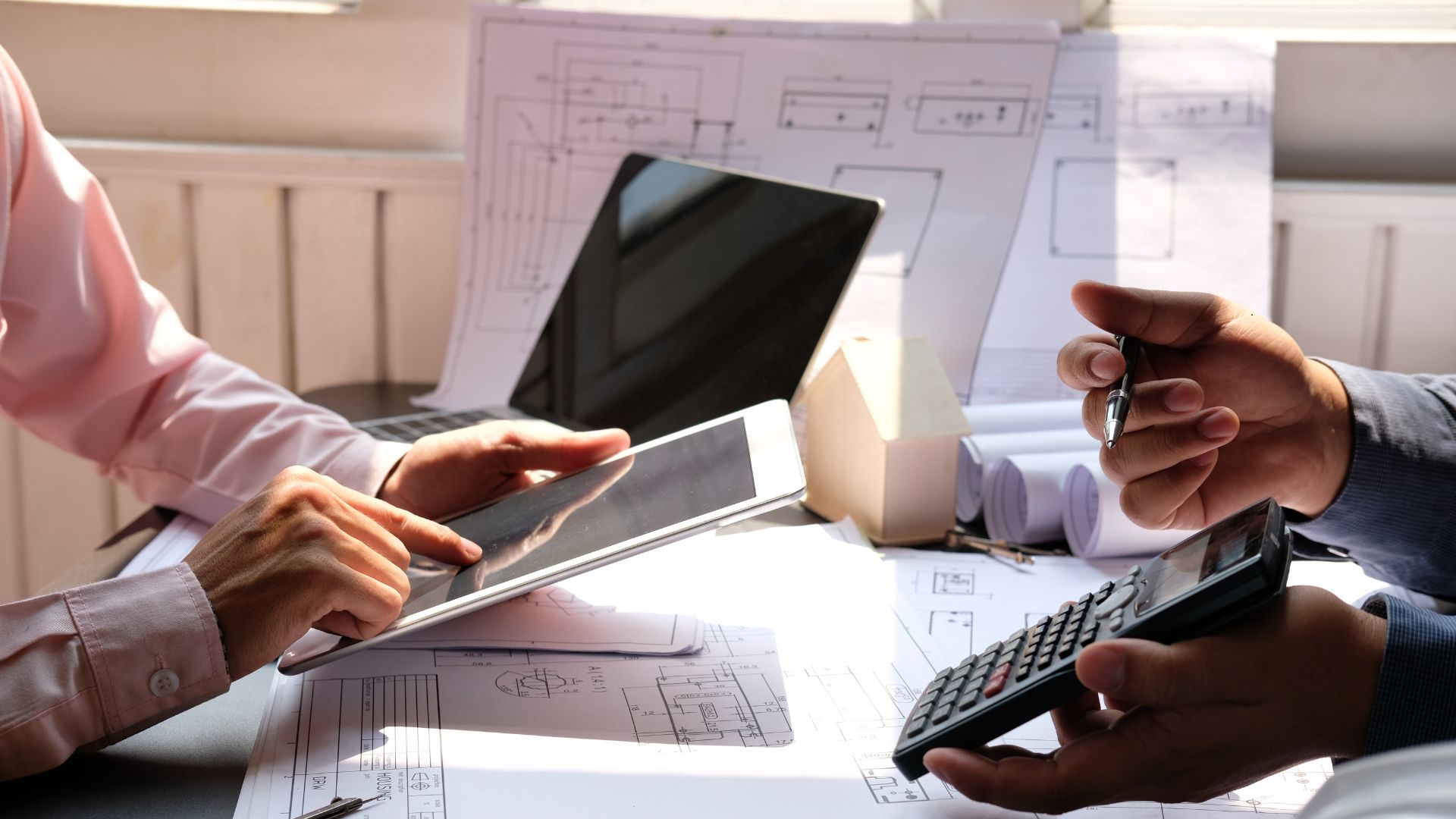 construction managers estimating costs before building
