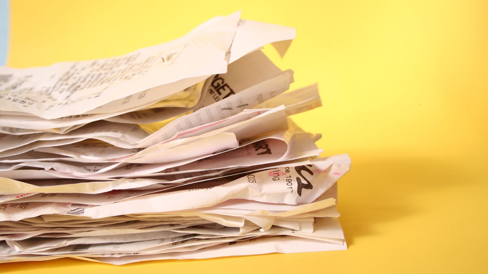 piles of receipts from an electricians ute 