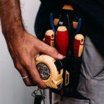 electrician with tools getting ready for a job