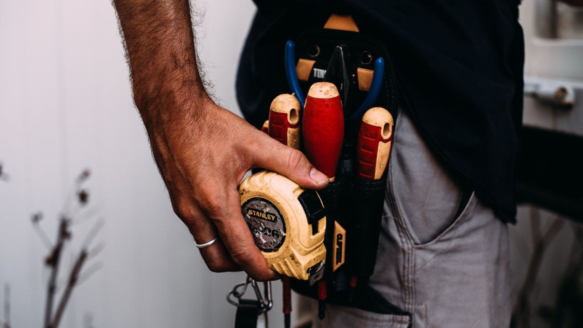 electrician with tools getting ready for a job